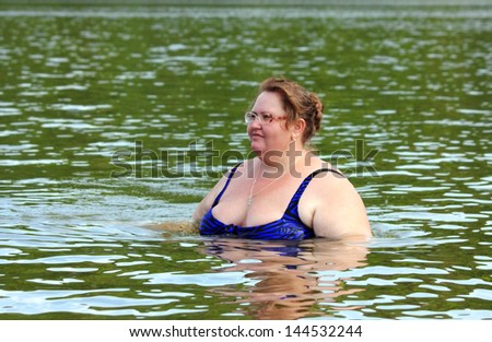 portarit of plump woman bath in river
