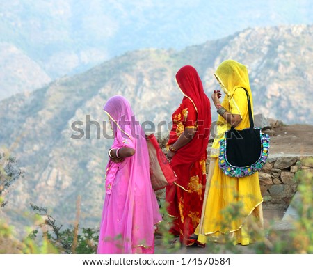 Indian women in colorful saris looking from top of hill