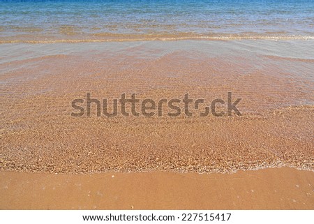 shallow of sea on gold sand beach