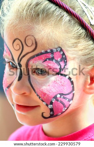 cute little girl with makeup painted face
