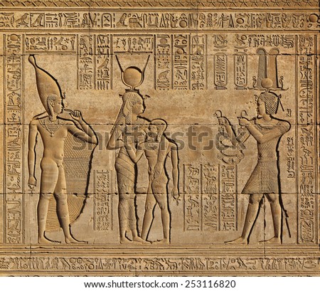 Hieroglyphic carvings on the exterior walls of an ancient egyptian temple
