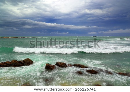Beautiful sea stormy landscape over rocky coastline in Indian ocean
