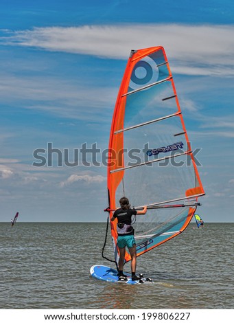 Dolzhanskaya spit, Russia - June 13, 2014: Strong wind in summer attracts many lovers of windsurfing and kitesurfing in the Dolzhanka, Krasnodar region, Russia.