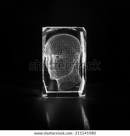 Three-dimensional projection of a human head. Laser engraving inside the glass.