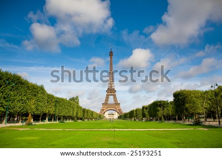 The Eiffel Tower in the morning with some clouds in the sky. Summer time