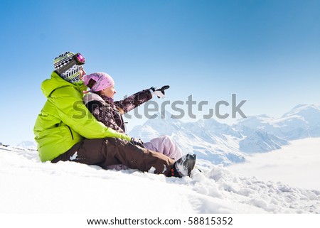 Young happy couple in snowy mountains. Winter sport vacation