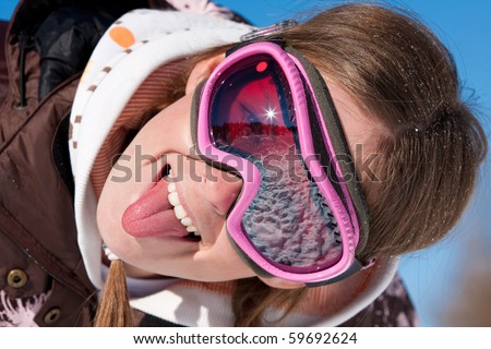 Funny close portrait of a young girl in ski mask