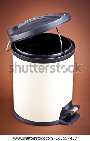 Modern refuse bin on a brown background