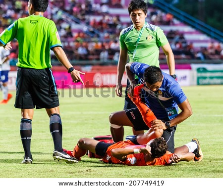 SISAKET THAILAND-JULY 23: First aid team of Sisaket FC. (blue) in action during Thai Premier League between Sisaket FC and Songkhla Utd at Sri Nakhon Lamduan Stadium on July 23,2014,Thailand