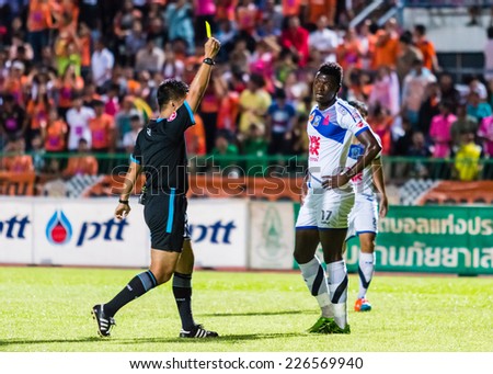 SISAKET THAILAND-OCTOBER 22: The referee (black) show the yellow card during Thai Premier League between Sisaket FC and Air Force Central FC at Sri Nakhon Lamduan Stadium on October 22,2014,Thailand