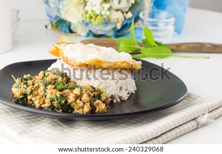 Thai spicy food -Dish of rice - egg and stir fried chiicken with basil