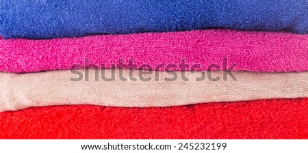Heap of colorful dry cotton towels texture