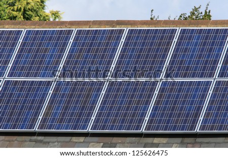 Solar photovoltaic panels mounted on a tiled house roof