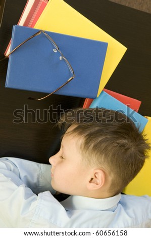 Schoolboy with books. Sleeps.