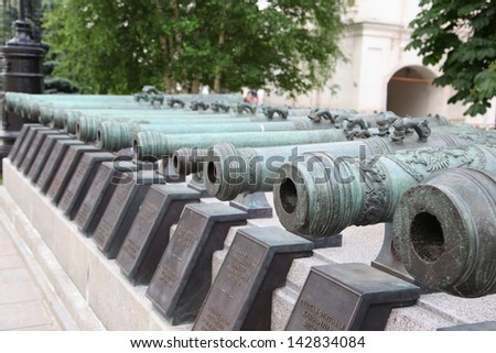 Historic cannon and balls in front of a church at the Kremlin. War and Peace united at the Kremlin.