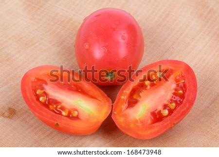 Tomatoes with water drops Tomato pieces isolated on white background