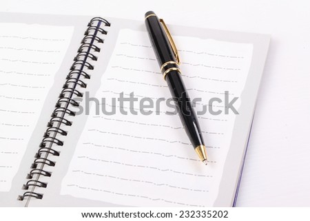 Blank open notebook with black pen isolated on white