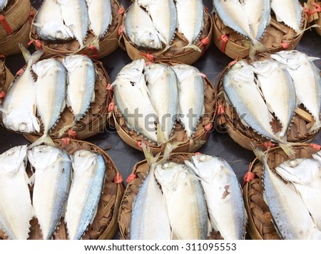 Mackerel steamed in bamboo bask.Thai gulf fish boiled cooking ready to eat pre sale in bamboo tray display for customer in tradition market thai people called this fish is platoo .select focus.