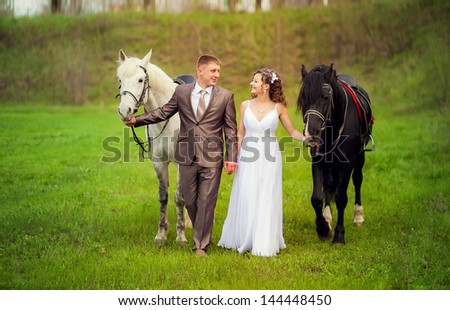 Wedding. The bride and groom with horses