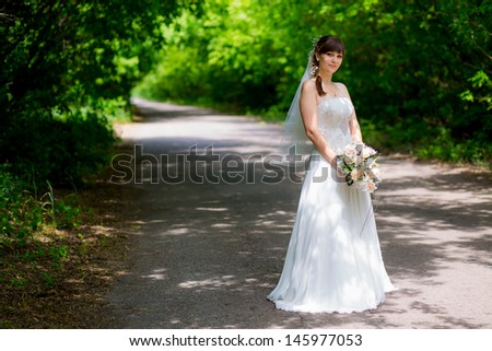 Happy beautiful bride with wedding makeup and hairstyle in bridal day smiling and waiting for groom. Attractive newlywed woman have final preparation for wedding. Gorgeous bride. Happy rich bride