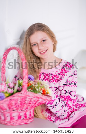 girl on the bed with a basket of flowers