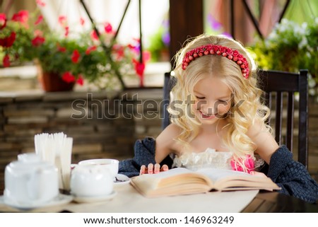 beautiful blonde girl reading an interesting book