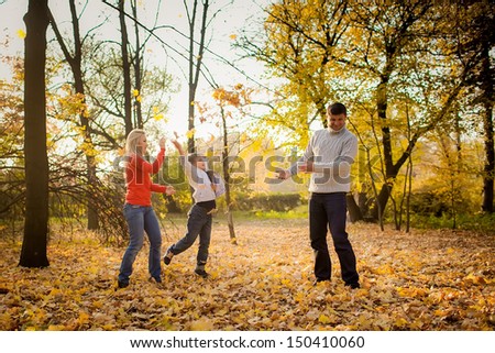 people throw autumn leaves