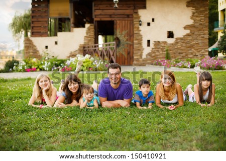 happy big family in the garden. looking at the camera