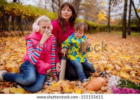 family tea party in the garden in autumn.  family ties, smile