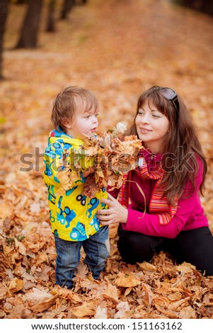 Mom and son playing in the autumn garden