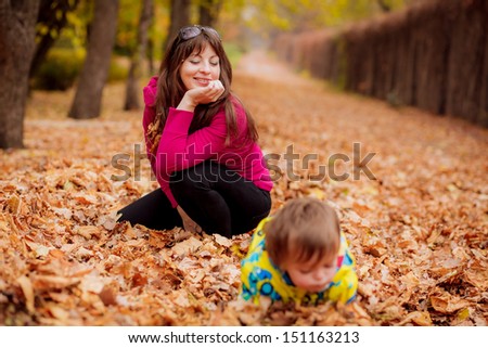 Mom and son playing in the autumn garden