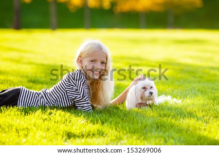 girl with a dog lap dog.  autumn landscape. close-up