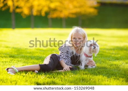 beautiful blond girl hugging a dog toy dog