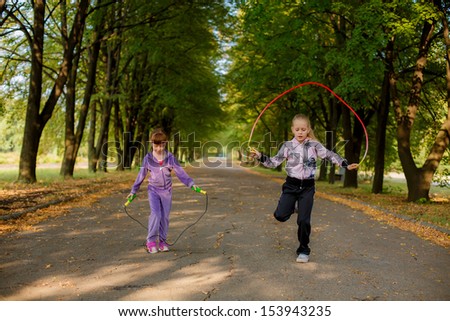 happy girl jumping on a skipping rope
