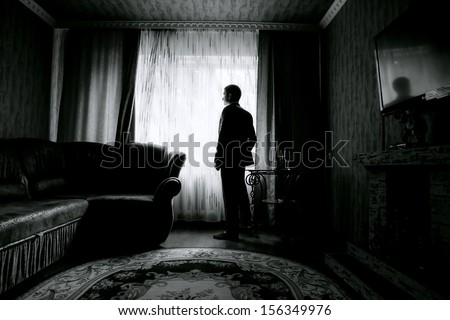 silhouette of the groom in the room. black and white