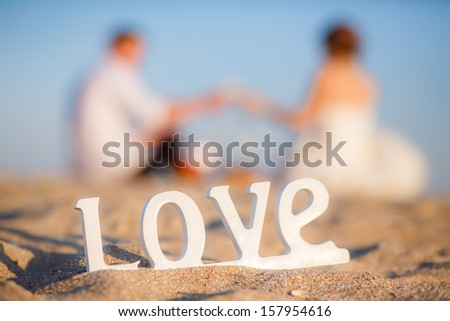 the word love, the couple in the background out of focus