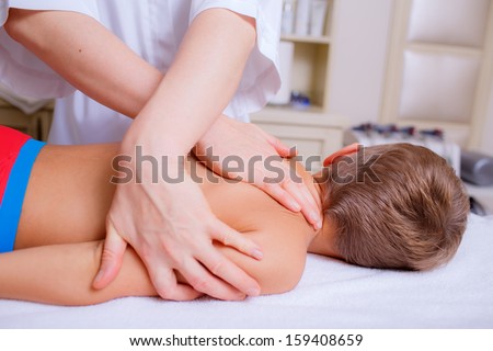 hands of the doctor close-up. baby massage. prevention of diseases of the spine