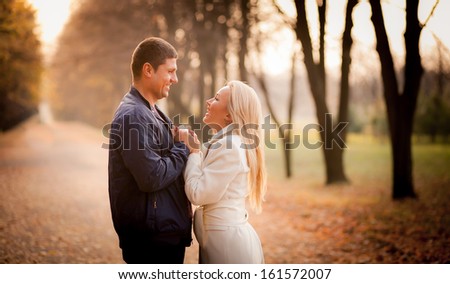 series. A love story. A man and a woman on autumn road. Love and relationships. Autumn sunset.