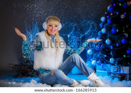 beautiful girl near the Christmas tree. blue decor