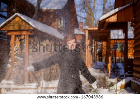 happy girl throws snow