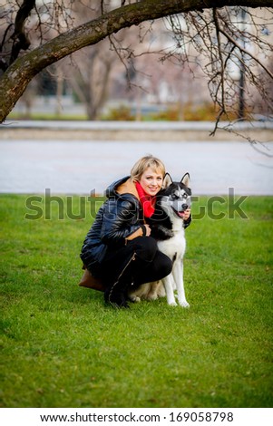 Friendship between human and dog. blue-eyed husky. walk in nature