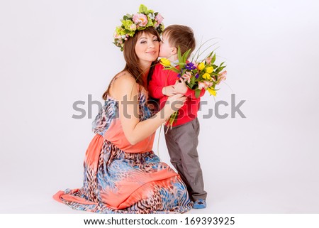 son gives mother flowers. Spring, March 8, International Women\'s Day.