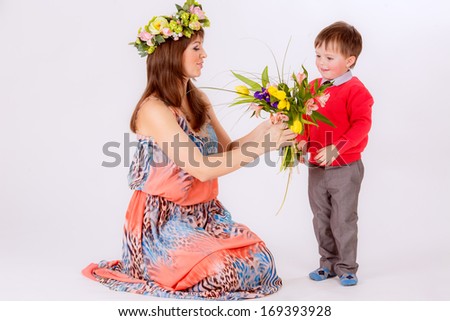 son gives mother flowers. hands holding a bouquet of tulips. Spring, March 8