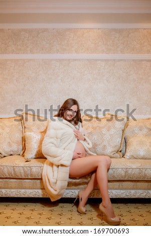 beautiful pregnant woman in a fur coat