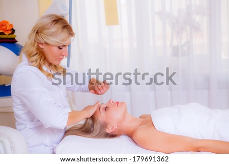 cosmetologist doing facial massage beautiful girl. Beauty, health and beauty skin