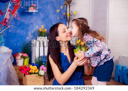 happy family. mother daughter in the room. daughter kissing mother. Mother\'s Day. March 8, International Women\'s Day.
