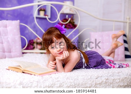 beautiful red-haired girl reading a book room
