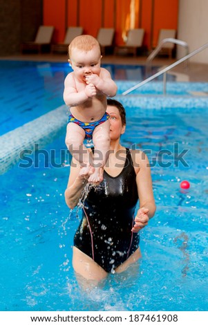 coach engage with the child in the pool. Swimming lessons for children. health