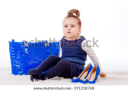 fashion portrait. Stylish little girl with shoes and bag mom. fashionista, shopping
