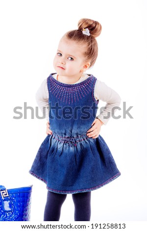 fashion portrait. Stylish little girl with shoes and bag mom. isolated on white background. fashionista, shopping